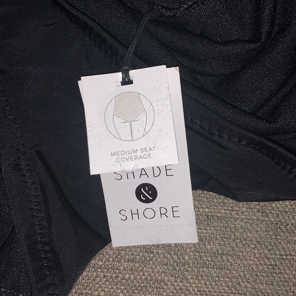 Cute black bathing suit. Mesh striping through middle. Size small NWT